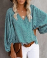 Detail of V-neck floral blouse featuring lantern sleeves and bohemian leaf pattern - S / Tops / Green Floral