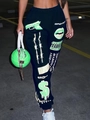 Dettaglio dei pantaloni sportivi neri con grafiche verde neon e borsa coordinata - S / Nero (Stampa Pistola Verde Neon)
