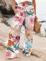 Détail de la taille haute froncée et de l'imprimé floral tropical sur le pantalon large - Rose