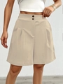 Detail of high waisted wide leg shorts in beige with double button and pleated texture - Apricot