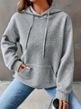 Detailed view of the grey waffle knit texture and kangaroo pocket on this hooded sweatshirt - Gray