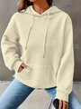 Detailed macro view of beige hooded sweatshirt with square embossed waffle texture fabric - Apricot