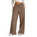 Detail view of brown wide-leg trousers with elastic drawstring waist and vertical pleats - Brown