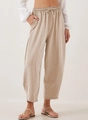 Close-up of beige high-waisted casual trousers featuring drawstring waist and side pockets - Apricot