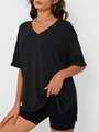 Detail view of the side slit hem and soft cotton fabric texture of the black V-neck t-shirt - S / Black