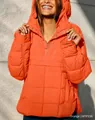 Detail of orange quilted hoodie jacket featuring side zippers and buttoned collar - S / Tops / Orange