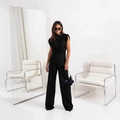 Detail of minimalist black sleeveless top with asymmetrical hem and wide leg pants - S / Black