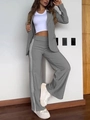 Detail van een donkergrijze blazer en wijde broek met witte strepen aan de zijkant - S / Boven- En Onderstuk / donkergrijs
