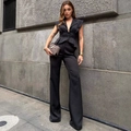 Elegant two-piece black suit set featuring a sleeveless ruffled vest and wide-leg trousers - S / Sleeveless Peplum Top And Wide Leg Pants / Black