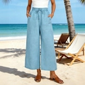 Dettaglio di pantaloni larghi in lino azzurro con coulisse in vita e tasche laterali - S / Azzurro