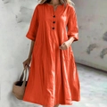 Detail van helder oranje katoen-linnen jurk met V-hals en drie zwarte knopen aan voorkant - S / Dresses / Oranjerood