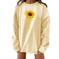 Detail van de zonnebloemprint en Jesus-tekst op het beige oversized sweatshirt - S / Abrikoos