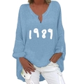 Detail view of light blue cotton linen shirt with 1989 print and side button accents - S / Tops / Sky Blue 1989 Print (1269X)