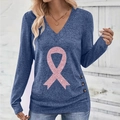 Detail of V-neck top showing pink glitter ribbon print and decorative side buttons - S / Blue