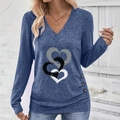 Detail of V-neck top showing interlocking heart print and decorative side buttons - S / Blue