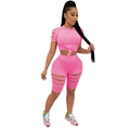 Detailed view of pink two-piece set featuring cutout details on sleeves and cycling shorts - S / Pink