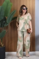 Detailed view of women's V-neck short sleeve top and wide-leg pants with abstract prints - Green