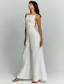 Detail of white wide-leg jumpsuit showing backless cut and premium draped fabric - S / White