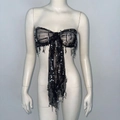 Dettaglio del top a fascia con paillettes nere a forma di fiocco e nappe di perline - S / Nero
