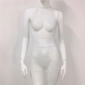 Detalle de conjunto de dos piezas de malla con pedrería blanca, top halter y minifalda - Talla única / Blanco