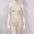 Detailaufnahme des Mesh-Stoffs mit funkelnden Strasssteinen an Neckholder-Top und Minirock - Einheitsgröße / Oberteil Und Unterteil / Hautfarben