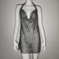 Close-up of sparkling silver rhinestone mesh fabric on a sexy halter neck party dress - Black