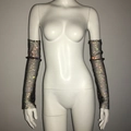 Detail view of long fishnet arm sleeves with shimmering rhinestones on a white mannequin - Black AB Rhinestone