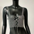 Close-up of sparkling rhinestone crop top with criss-cross metal chain details - One Size / Black