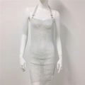 Detail eines silbernen Strass-Netzkleids mit Neckholder-Ausschnitt und offenem Rücken - Halter Kleid / Weißes Blazerkleid