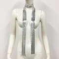 Macro detail of a silver metallic sequin skinny scarf with reflective punk style texture - Silver