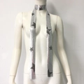 Close-up of silver sequin metal mesh scarf featuring black five-point star patterns - Long Scarf / Star Silver