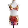 Close-up of holographic rhombus sequins and gold metal chain links on a two-piece dress set - Orange