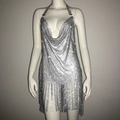 Close-up of silver rhinestone mesh dress featuring a deep V-neck and sparkling tassel hem - S / Silver