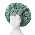 Detail of grey-green satin sleep cap with large bow knot on a mannequin head - Grass Green Cross Sleep Bonnet