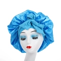 Detailed close-up of a bright blue satin sleep bonnet with a large decorative bow on a model - Lake Blue