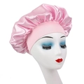 Pink satin sleep bonnet for kids with wide elastic headband shown on a model head - Pink
