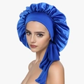 Detail view of royal blue satin sleep bonnet featuring adjustable ribbon ties and silk texture - Sapphire Blue