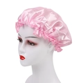 Pink satin sleeping cap with elastic lace edge shown on a model head for hair care - One Size / Pink