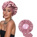 Detail of pink satin sleep bonnet with bow tie and wide band for hair protection - Bean Paste Pink Style