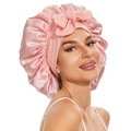 Pink satin hair bonnet with a bow tie design for sleeping and hair protection - Nude Pink Cross Sleep Bonnet