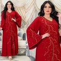 Detail of red Abaya dress featuring golden wave embroidery and luxury beadwork on sleeves - S / Red