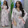 Detail of colorful sequins and pink tassels on bohemian print kaftan dress sleeves - Gray