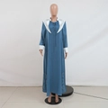 Detail view of contrast white lapels with hollow embroidery on blue jalabiya dress - S / Blue