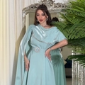 Detail of evening gown with satin fabric cape sleeves and large round rhinestone belt buckle - S / Mint Green
