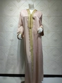 Detail of golden embroidery and sphere buttons on the champagne velvet kaftan sleeve - Champagne