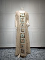 Detailed close-up of champagne chiffon abaya with geometric sequin embroidery and gold trim - Apricot
