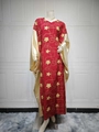 Close-up detail of golden embroidery and satin sleeve on red bohemian kaftan dress - One Size / Wine Red