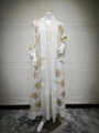 Detail of white abaya featuring gold palm tree embroidery and matching belted waist - White
