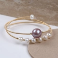 Detailed macro view of triple-layered 14K gold filled bracelet with freshwater pearls - Multi-layer Wrap with Large Purple Pink Pearl (NO.1)