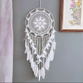 White handmade dream catcher with feathers and beads hanging against a grey wall - Sunflower Dreamy White